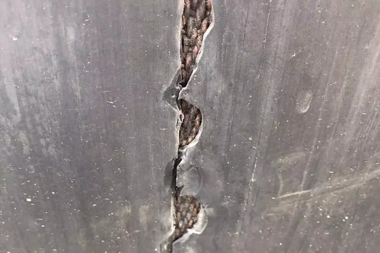 This is an image of a damaged conveyor belt found during an Onsite Conveyor Belt Inspection.